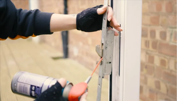 Locksmith installing commercial door hardware in Tuscaloosa