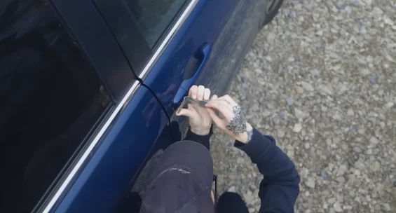 Technician cutting a replacement car key in Tuscaloosa