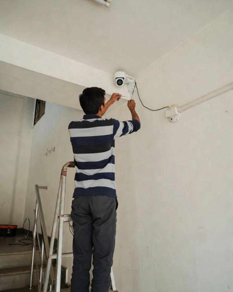 Technician installing a CCTV security camera in Tuscaloosa